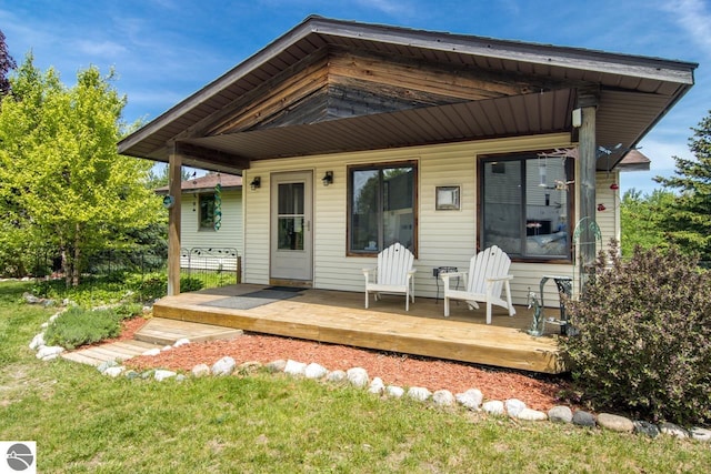 rear view of property with a wooden deck