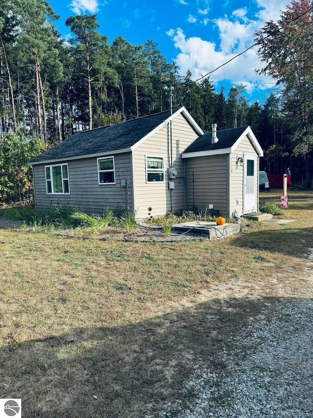 view of property exterior featuring a lawn