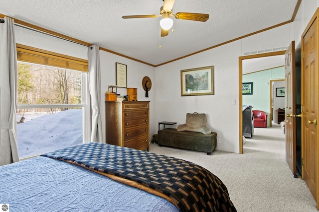 bedroom with a textured ceiling, lofted ceiling, carpet, and ornamental molding