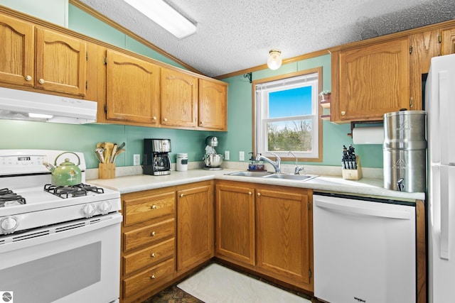 kitchen with white appliances, lofted ceiling, a sink, under cabinet range hood, and a textured ceiling