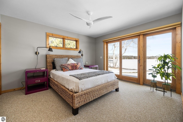 carpeted bedroom featuring access to exterior and a ceiling fan