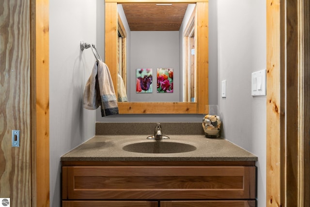 bathroom with wooden ceiling and vanity