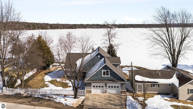 exterior space featuring a garage, stone siding, and fence