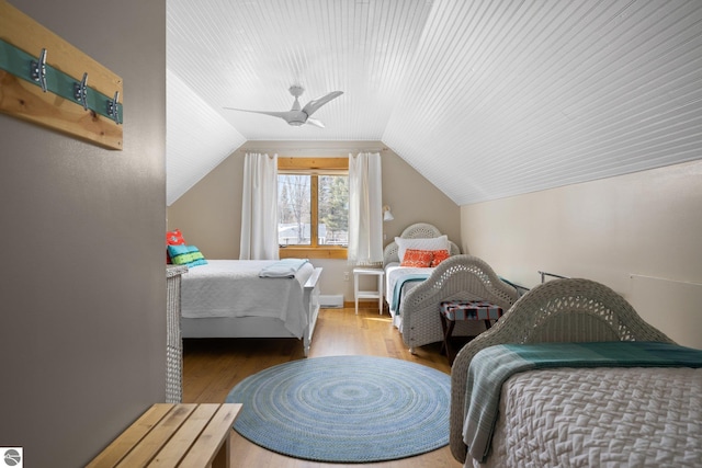 bedroom featuring lofted ceiling, wood finished floors, and ceiling fan