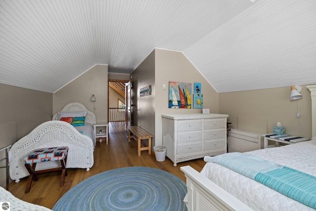 bedroom with vaulted ceiling and wood finished floors