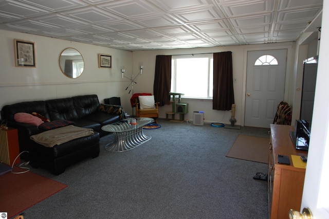 carpeted living area with an ornate ceiling