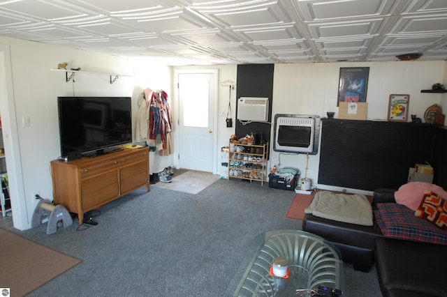 carpeted living area with heating unit and an AC wall unit