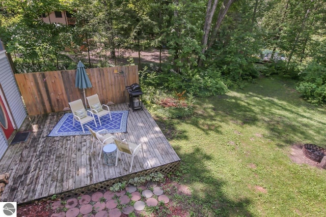 view of yard with a deck and fence