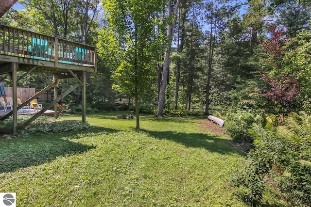 view of yard featuring stairs and a wooden deck