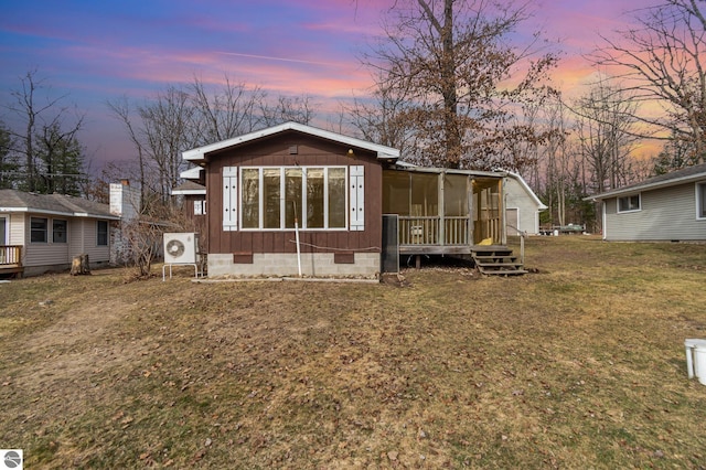 back of house with a yard, a sunroom, and crawl space