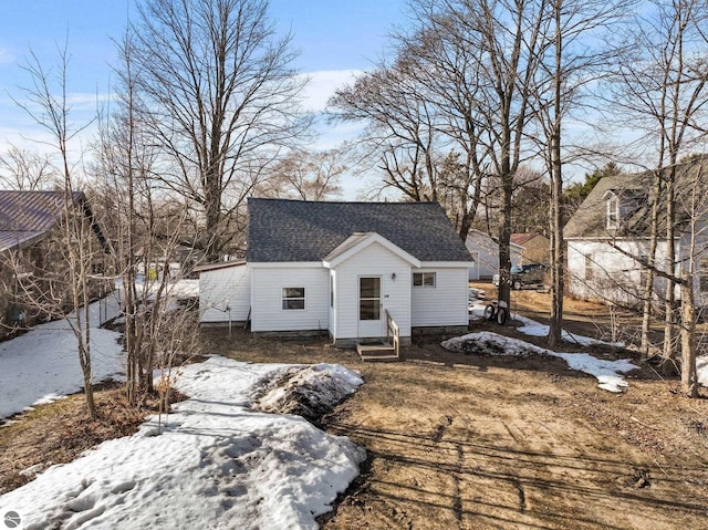 view of front of home featuring entry steps and a shingled roof