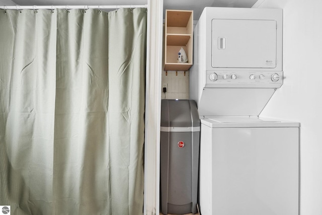 laundry area with laundry area and stacked washer and dryer