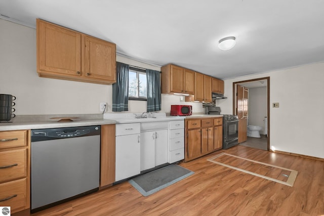 kitchen featuring light wood-style flooring, under cabinet range hood, black gas range oven, light countertops, and dishwasher