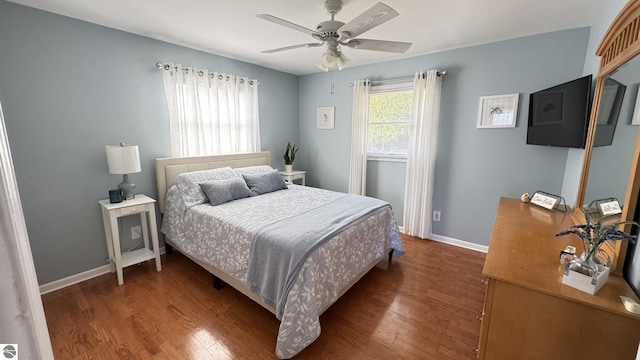 bedroom with ceiling fan, baseboards, and wood finished floors