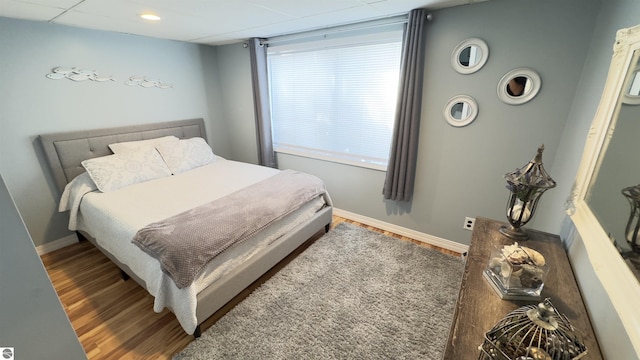 bedroom with baseboards and wood finished floors