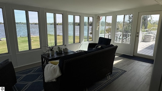 sunroom / solarium featuring plenty of natural light and a water view