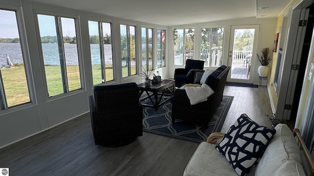 sunroom / solarium featuring a water view