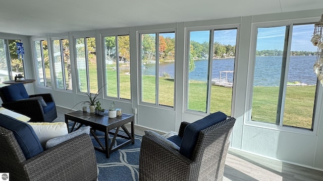 sunroom with plenty of natural light and a water view