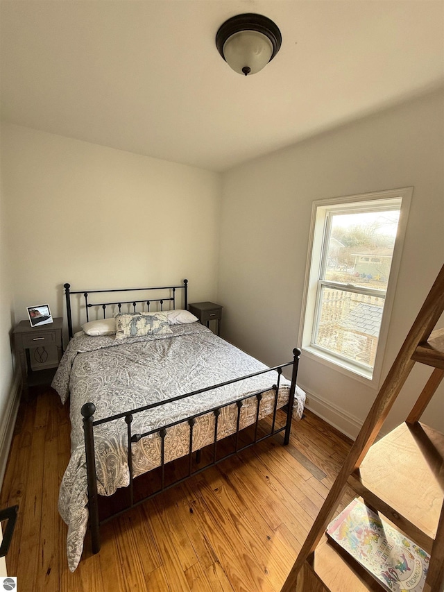 bedroom with baseboards and light wood finished floors