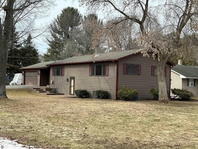 view of front of home with an attached garage and a front yard