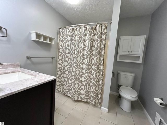 full bathroom featuring visible vents, toilet, vanity, tile patterned floors, and a textured ceiling