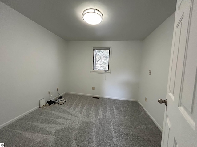 carpeted empty room with visible vents and baseboards