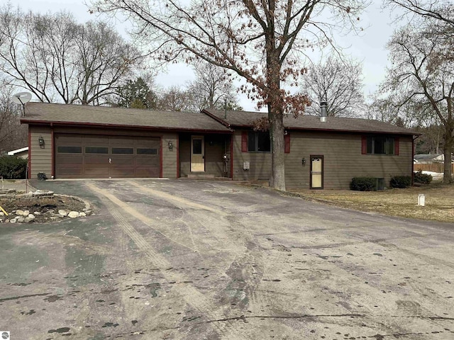 ranch-style house with driveway and an attached garage