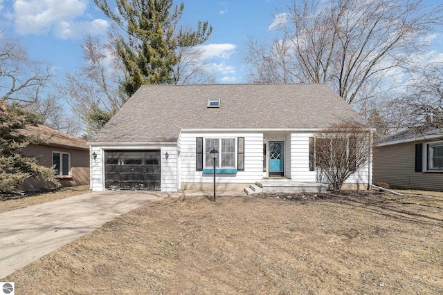 cape cod-style house with a garage, concrete driveway, and a shingled roof