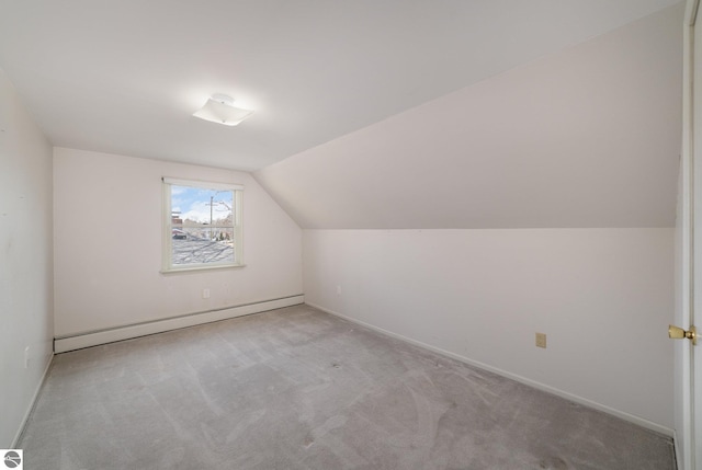 additional living space featuring baseboards, lofted ceiling, baseboard heating, and carpet