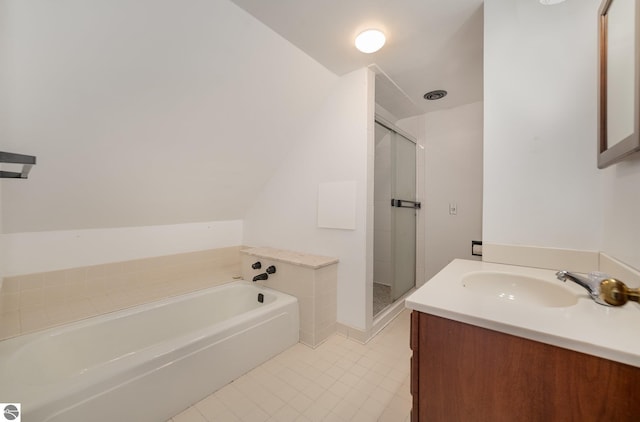 bathroom featuring tile patterned flooring, a shower stall, lofted ceiling, a bath, and vanity