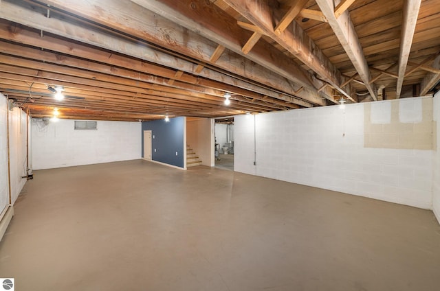 unfinished basement featuring stairs