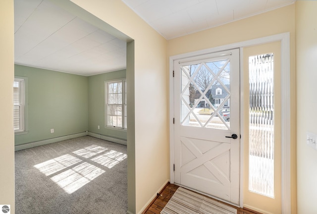 carpeted foyer entrance featuring baseboards and baseboard heating