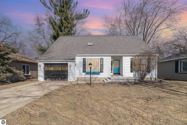 view of front of property with an attached garage and concrete driveway