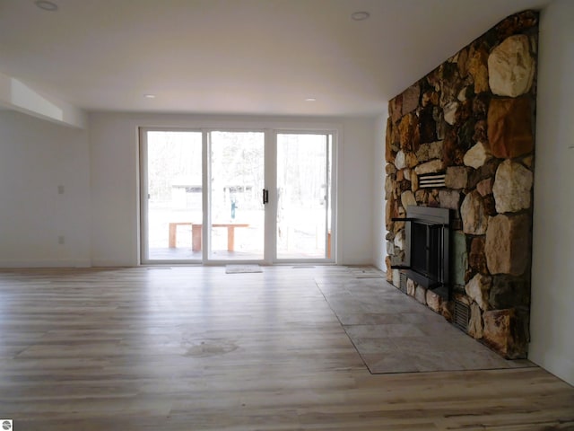4177 Seminole St, Gladwin, MI 48624 - unfurnished living room with wood finished floors and a fireplace