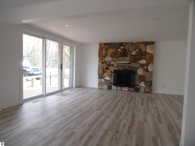 4177 Seminole St, Gladwin, MI 48624 - unfurnished living room with wood finished floors and a stone fireplace