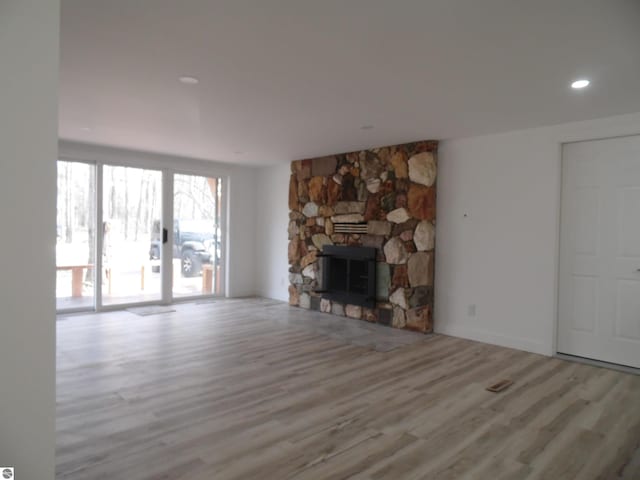 4177 Seminole St, Gladwin, MI 48624 - unfurnished living room featuring wood finished floors, a fireplace, and recessed lighting