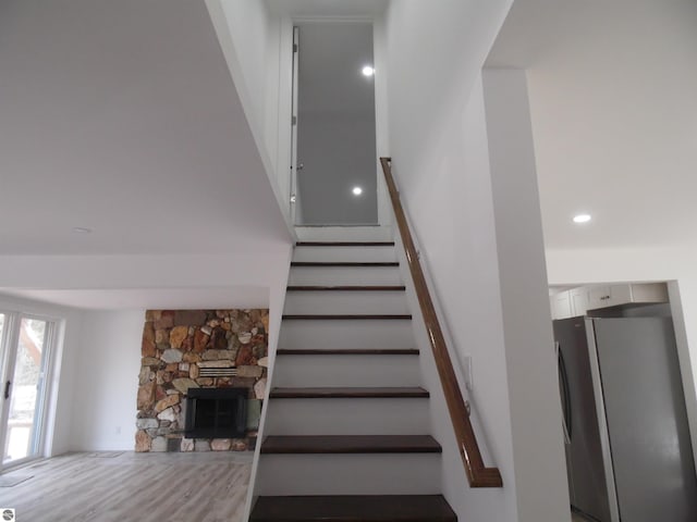 4177 Seminole St, Gladwin, MI 48624 - staircase featuring a stone fireplace and recessed lighting