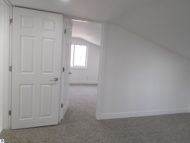 4177 Seminole St, Gladwin, MI 48624 - additional living space with carpet floors, lofted ceiling, and baseboards