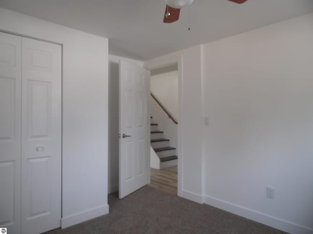 4177 Seminole St, Gladwin, MI 48624 - unfurnished bedroom with carpet, baseboards, a closet, and a ceiling fan