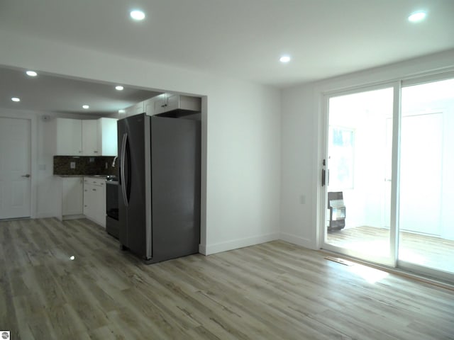 4177 Seminole St, Gladwin, MI 48624 - kitchen featuring fridge with ice dispenser, light wood-type flooring, white cabinetry, recessed lighting, and baseboards