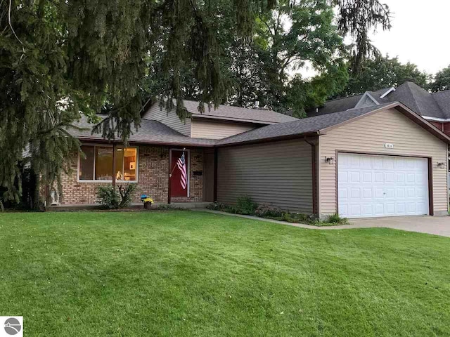 ranch-style home featuring brick siding, an attached garage, driveway, and a front yard