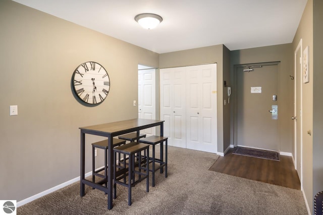 carpeted dining space with baseboards