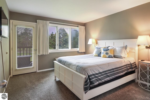 bedroom featuring access to exterior, dark carpet, and baseboards