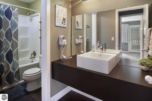 bathroom featuring vanity, toilet, and shower / tub combo with curtain