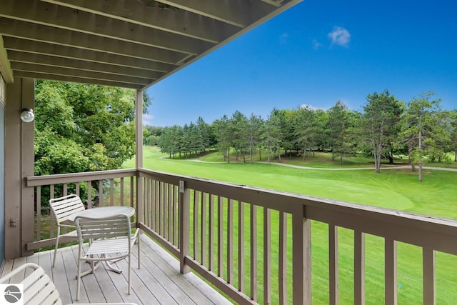 wooden terrace featuring a yard