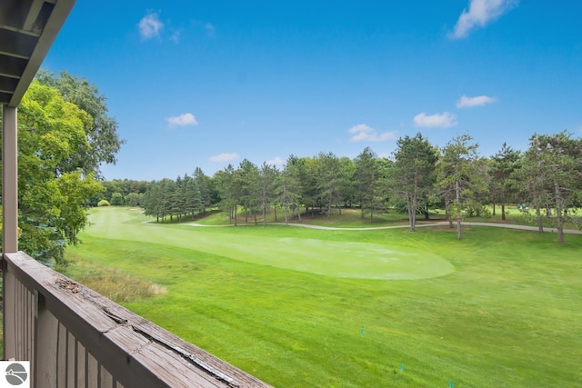 surrounding community featuring a yard and golf course view