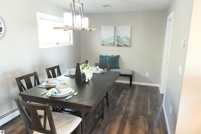 5661 Golfridge Rd, Alma, MI 48801 - dining area featuring a baseboard radiator, baseboards, visible vents, and wood finished floors