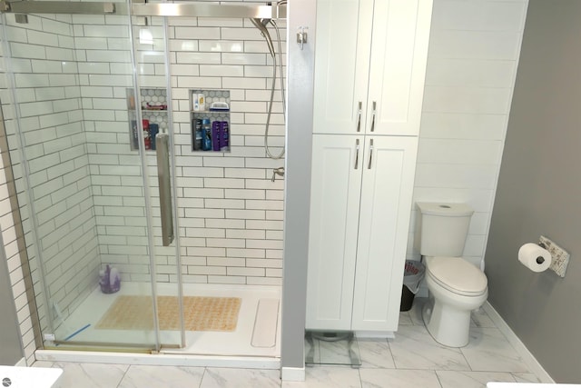 5661 Golfridge Rd, Alma, MI 48801 - bathroom featuring toilet, baseboards, marble finish floor, and a stall shower