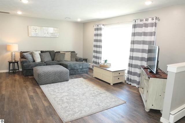 5661 Golfridge Rd, Alma, MI 48801 - living room featuring dark wood-style floors, visible vents, recessed lighting, and a baseboard radiator