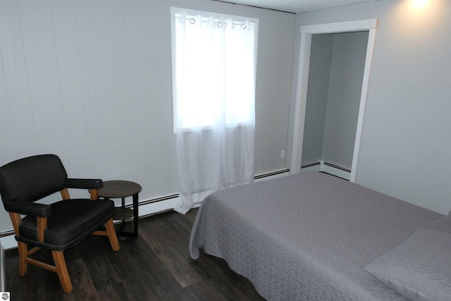 5661 Golfridge Rd, Alma, MI 48801 - bedroom with a baseboard heating unit and wood finished floors